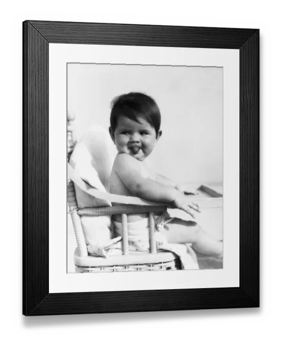 Framed Print : Baby sitting in high chair, sticking out tongue. (Photo by H. Armstrong Roberts  /  Retrofile  /  Getty Images)