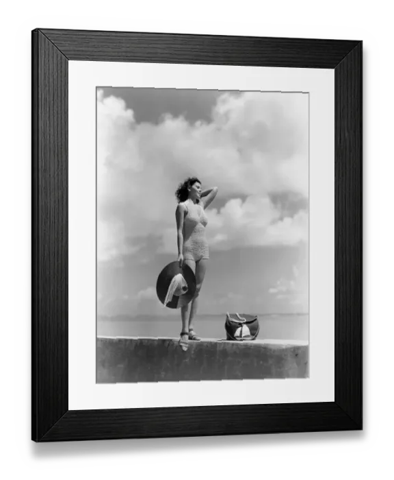 Framed Print : Woman Wearing Knit Bathing Suit Standing Wall Ocean Sea Background Holding Sun Hat Beach Bag Sail Boat Fashion Beauty Style Swim Wear Retro Framed Print : Woman Wearing Knit Bathing Suit Standing Wall Ocean Sea Background Holding Sun Hat Beach Bag Sail Boat Fashion Beauty Style Swim Wear Retro