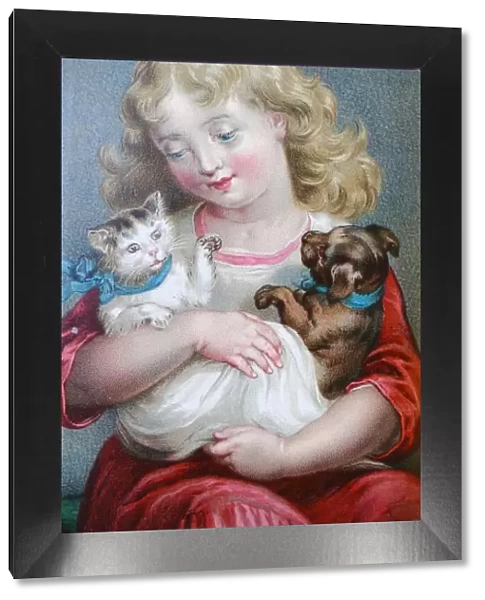 Blond girl sitting and holding a young cat and dog in her arms