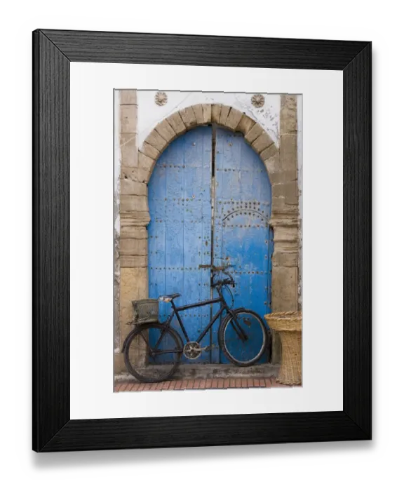 Framed Print : Morocco, Essaouira, bicycle propped against blue painted door Framed Print : Morocco, Essaouira, bicycle propped against blue painted door