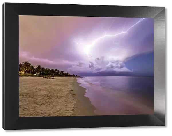 Amazing lightning storm sunset and calmed ocean, at Naples beach, Florida, USA