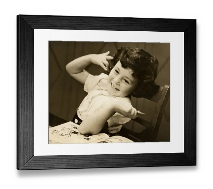 Framed Print : Young girl with coloring book and crayon