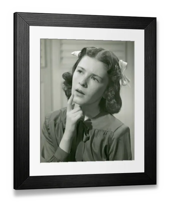 Framed Print : Young woman with hand on chin Framed Print : Young woman with hand on chin