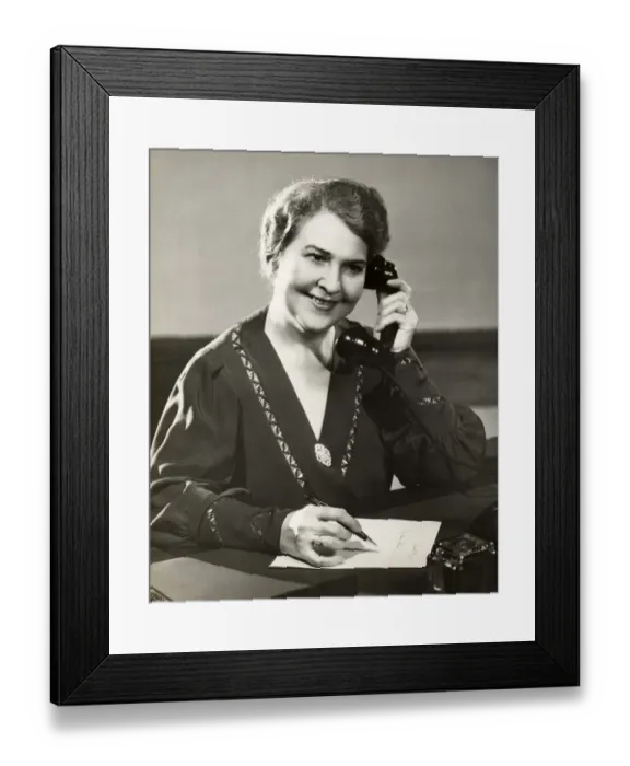 Framed Print : Mature woman on telephone and writing note