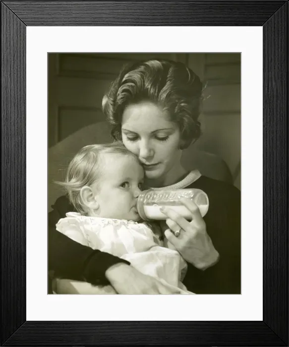 Framed Print : Mother feeding baby girl Framed Print : Mother feeding baby girl