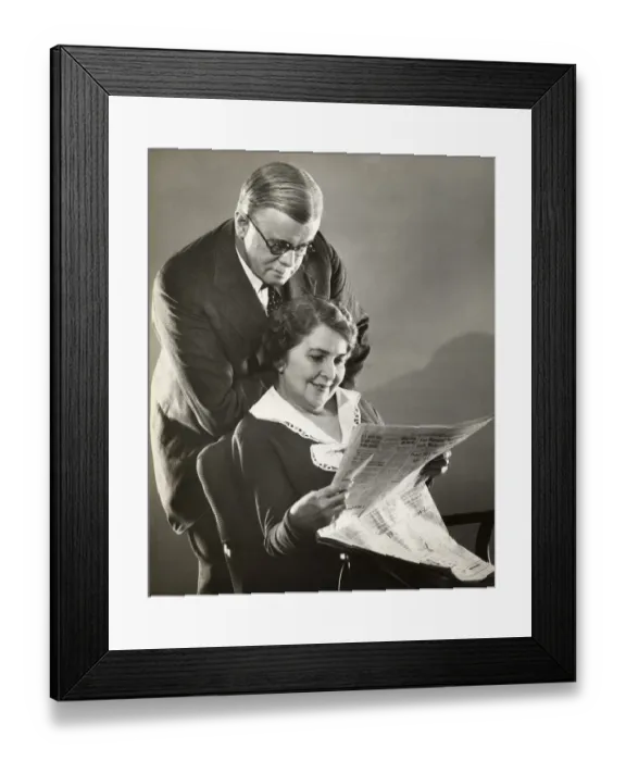 Framed Print : Mature couple reading newspaper together Framed Print : Mature couple reading newspaper together