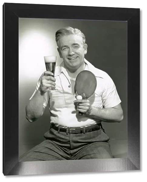Man holding drink and paddle