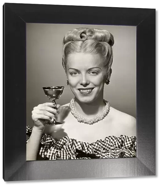 Portrait of woman with upraised glass