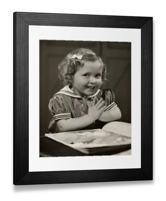 Framed Print : Young girl with book praying Framed Print : Young girl with book praying