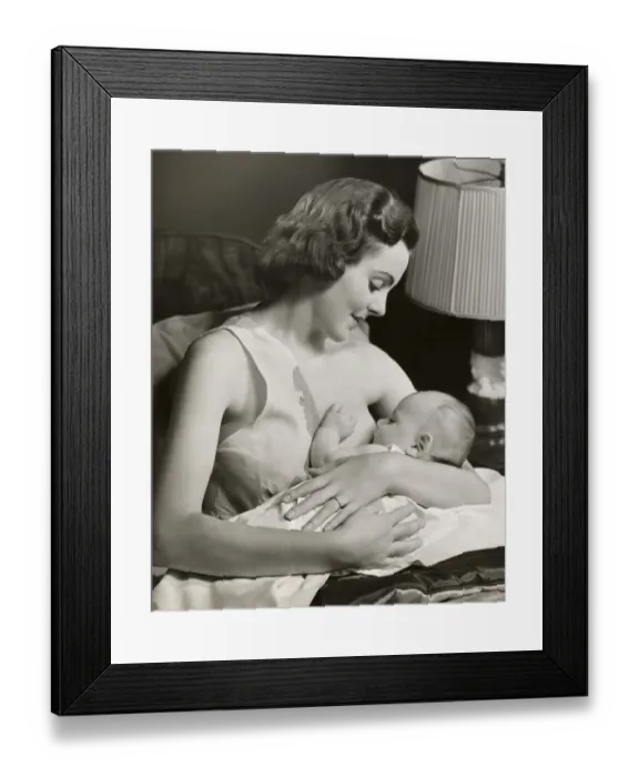 Framed Print : Infant being nursed by mother Framed Print : Infant being nursed by mother