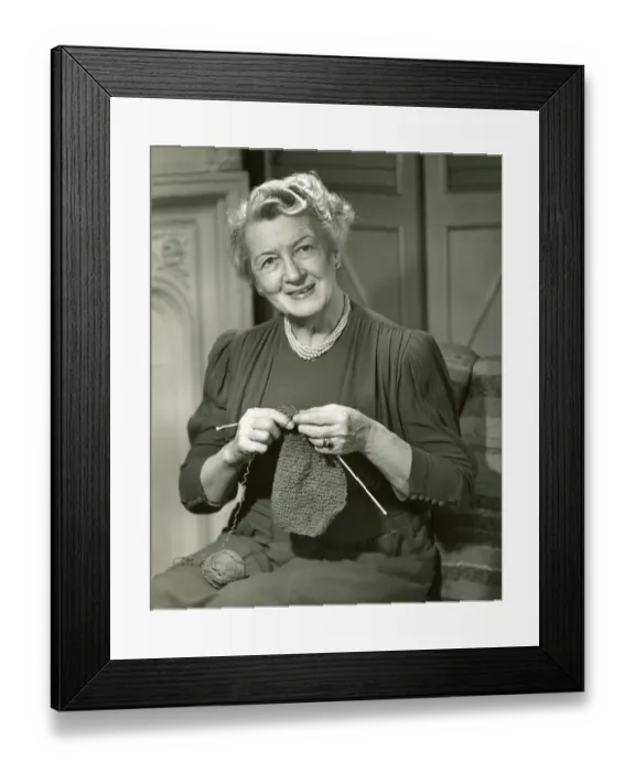 Framed Print : Smiling woman knitting Framed Print : Smiling woman knitting