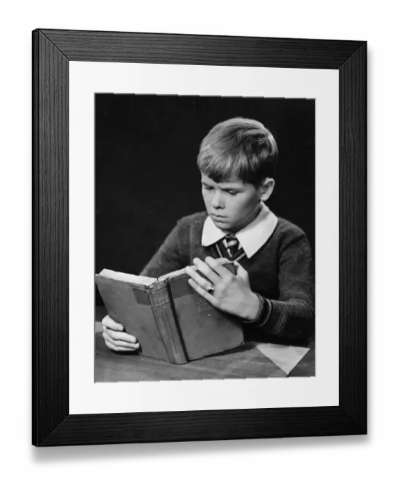 Framed Print : Young boy reading book Framed Print : Young boy reading book