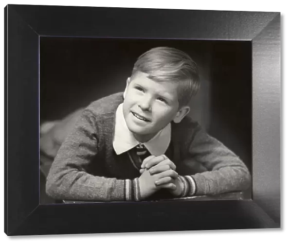 Young boy with his hands folded