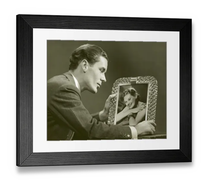 Framed Print : Man gazing at framed photo of woman Framed Print : Man gazing at framed photo of woman