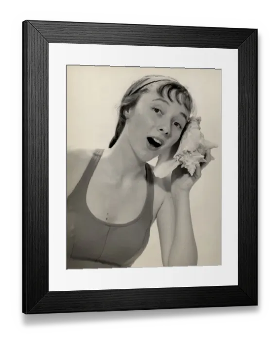Framed Print : Woman listening to conch shell Framed Print : Woman listening to conch shell