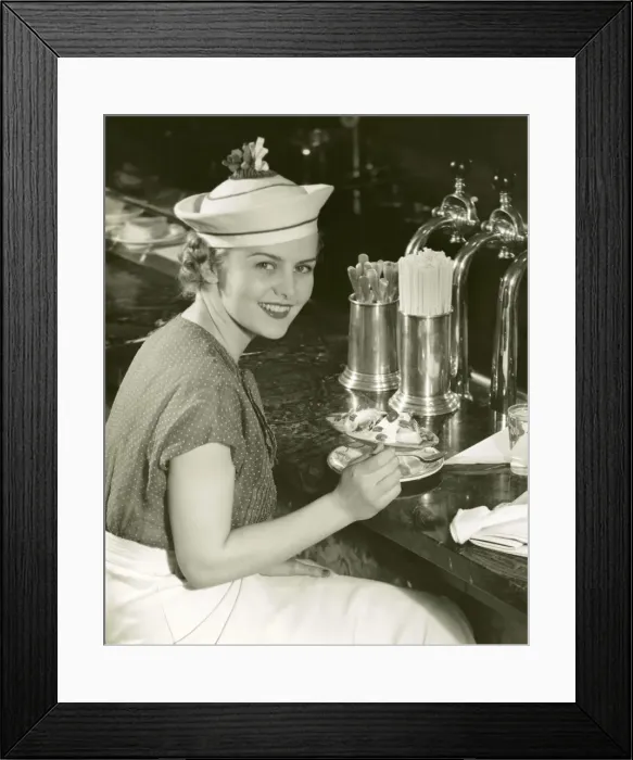 Framed Print : Woman at soda fountain with banana split Framed Print : Woman at soda fountain with banana split