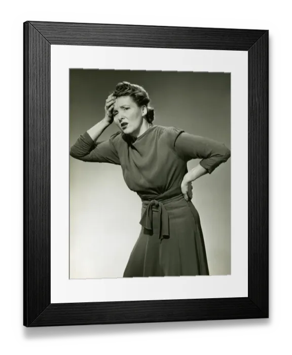 Framed Print : Woman in pain clutches head and back