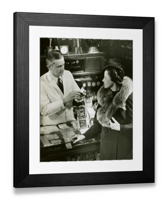 Framed Print : Pharmacist fills prescription for woman Framed Print : Pharmacist fills prescription for woman