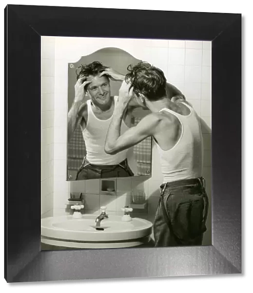 Man in undershirt massaging scalp