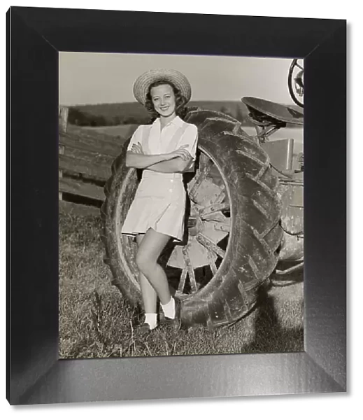 Teenage girl with farm tractor