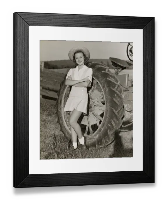 Framed Print : Teenage girl with farm tractor Framed Print : Teenage girl with farm tractor