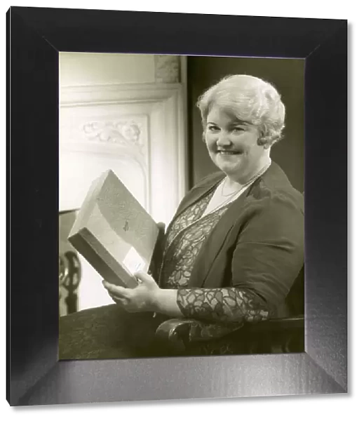 Portrait of a woman holding box