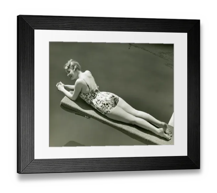 Framed Print : Woman in bathing suit lying on diving board Framed Print : Woman in bathing suit lying on diving board