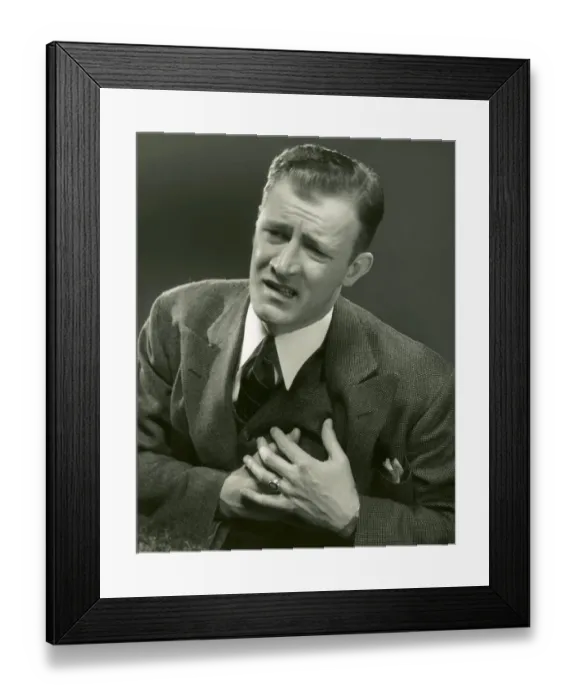 Framed Print : Man clutches left side of chest