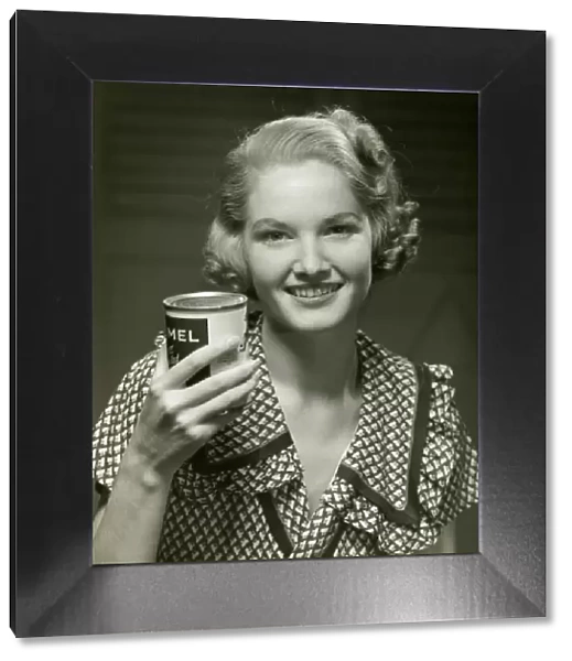 Woman holding can of food
