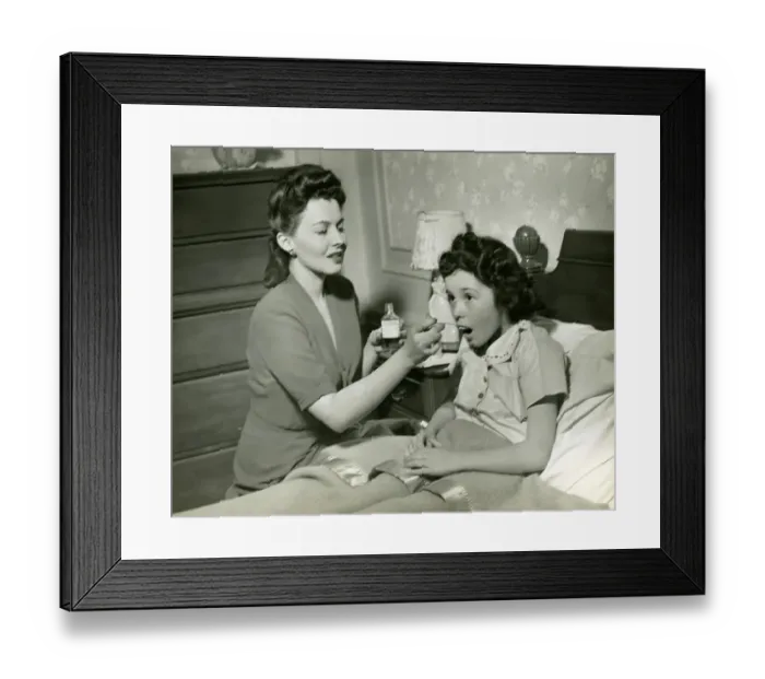 Framed Print : Mother giving medicine to girl Framed Print : Mother giving medicine to girl