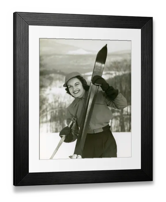 Framed Print : Woman holding skis on slope Framed Print : Woman holding skis on slope