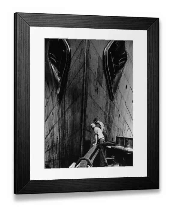 Framed Print : Liner Bow. A dramatic close-up of the bow of a liner at New York Docks, from a tug