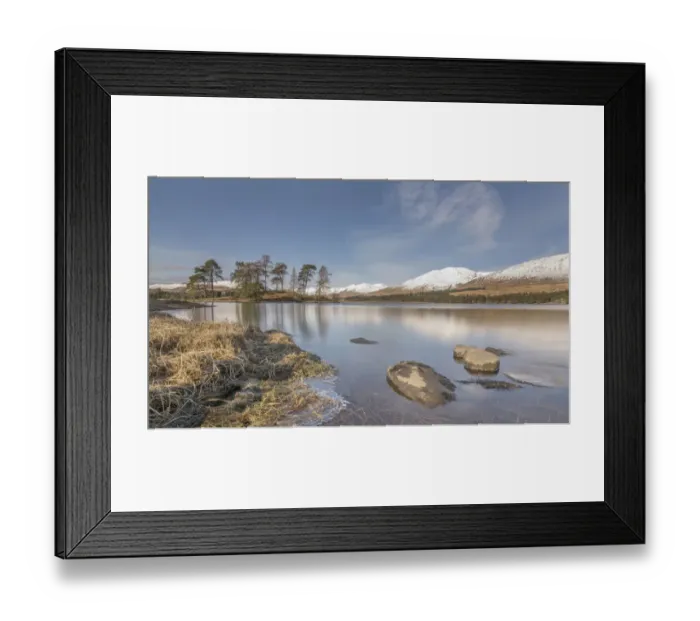 Framed Print : Loch Tula. Scottish Loch with rocks and trees with snowy mountains