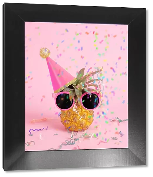 Pineapple with party hat and confetti