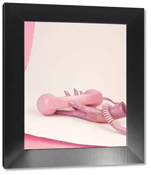 Pink phone and mannequin hand