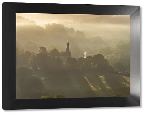 Hathersage church surrounded by the hills of the Peak District at sunrise. UK