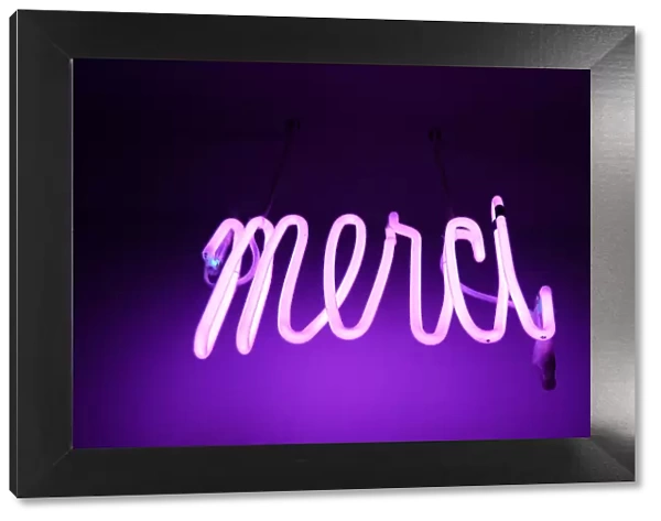 Merci. Pink and purple Neon light sign saying merci (thanks in french)