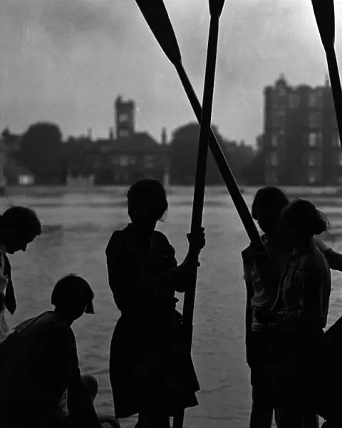 Stranded. 14th October 1931: Rowing girls are marooned by high tides on