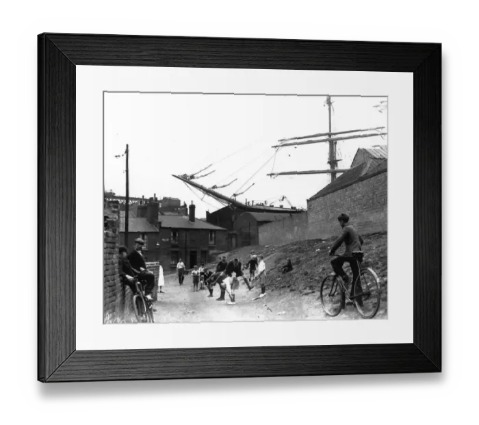 Framed Print : Schooner. Children playing a game of leap-frog near Millwall Docks