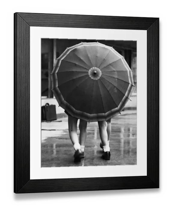 Framed Print : Rainy Day. 31st December 1938: Two little girls share an umbrella during a shower of rain Framed Print : Rainy Day. 31st December 1938: Two little girls share an umbrella during a shower of rain