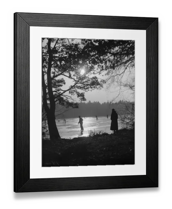 Framed Print : Twilight. 8th December 1933: A solitary figure comtemplates skaters on a frozen lake