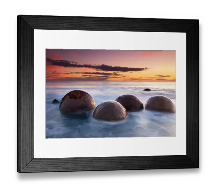 Framed Print : Spherical boulders in the sea at sunrise