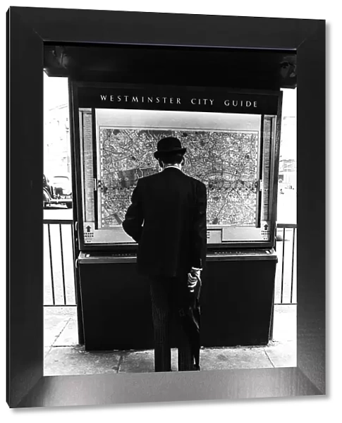 Gentleman in London looking at a city map