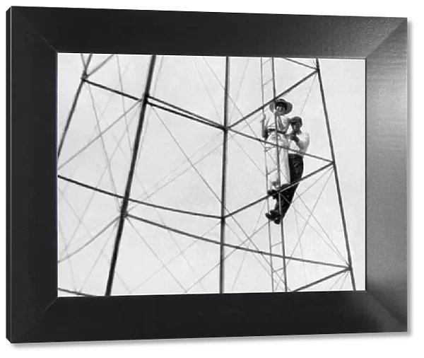 adolescent, adult, archival, black & white, boy, caucasian, climbing, electrical tower