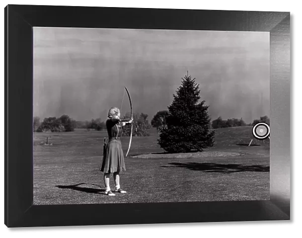 Woman Shooting Arrow at Archery Target