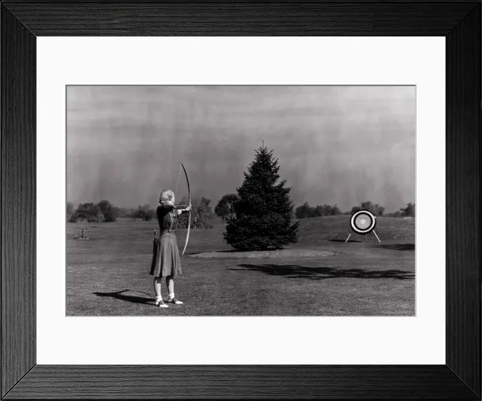 Framed Print : Woman Shooting Arrow at Archery Target Framed Print : Woman Shooting Arrow at Archery Target