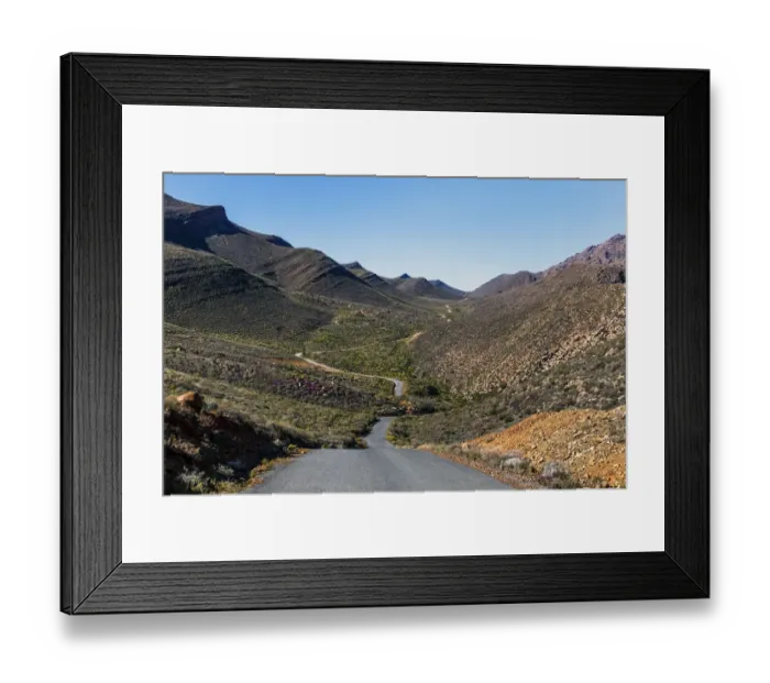 Framed Print : The winding road climbing up the remote and rugged wilderness area of the Cederberg mountains in the distance. Western Cape Province, South Africa Framed Print : The winding road climbing up the remote and rugged wilderness area of the Cederberg mountains in the distance. Western Cape Province, South Africa