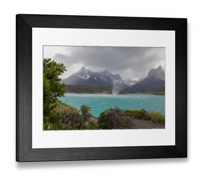 Framed Print : The wind whips up waves and a waterspout across the cold waters of Lake Pehue to the snow-capped mountain peaks of the Torres del Paine National Park in the Magallanes Region of Patagonia, Southern Chile Framed Print : The wind whips up waves and a waterspout across the cold waters of Lake Pehue to the snow-capped mountain peaks of the Torres del Paine National Park in the Magallanes Region of Patagonia, Southern Chile
