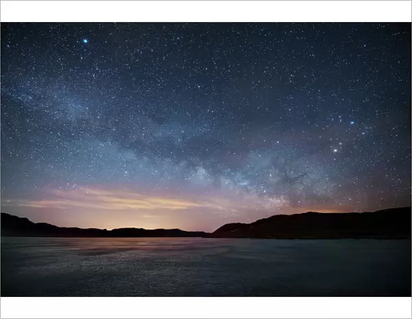 Milky Way floats above frozen lake, Front Range, Colorado, USA
