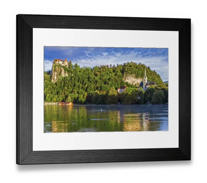 Framed Print : Castle rises on cliffs above Lake Bled, Slovenia